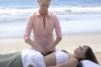 using hot stones to perform massage on the belly.