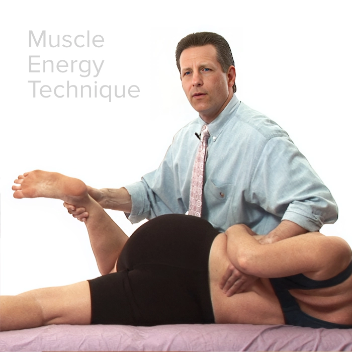 Tom ockler performing muscle energy technique on a massage client